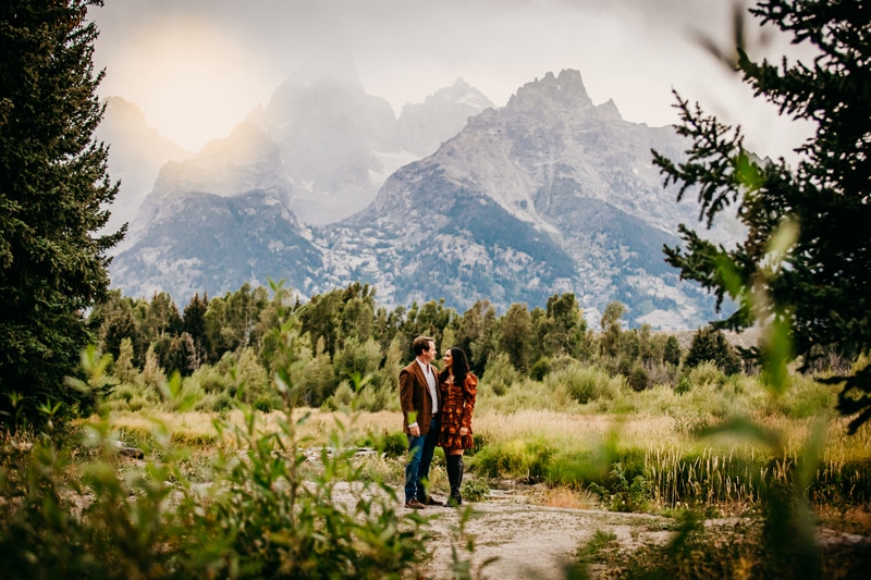 Couples Photographer, a man and woman stand together in green mountain meadows