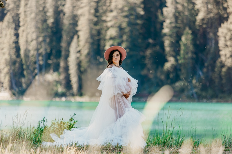 Maternity Photographer, a woman in maternity gown walks near lake