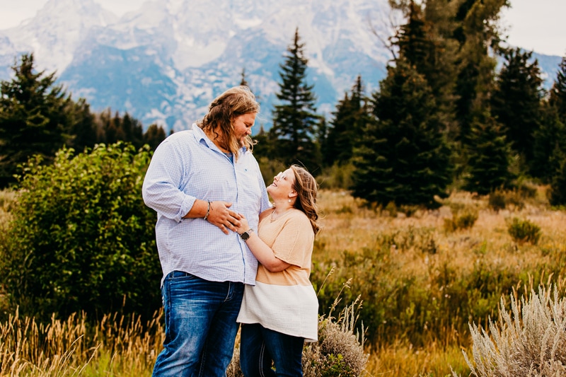 couples photographer, a young woman and man stand together in mountain meadows