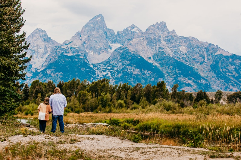 Couples photographer, a young couple lean into each other as they admire the mountains together