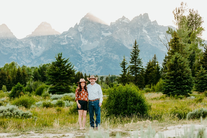Couples photographer, a husband and wife stand together in the mountain wilderness
