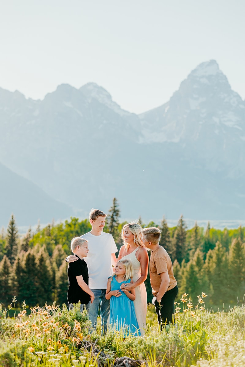 Family Photographer, a mother stands with her three boys and daughter in the mountain meadows