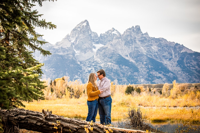 Couples Photographer, a man and woman draw close near Mountains meadows