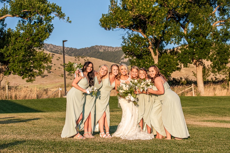 Wedding Photography, bridesmaids huddle close with smiles on the golf course