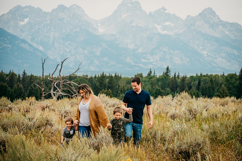 Family Photographer,  a young mother and father walk with their boys in the wilderness