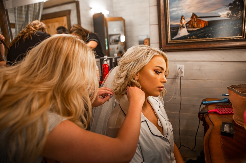 Wedding Photography, the bride to be is getting her hair done before her wedding
