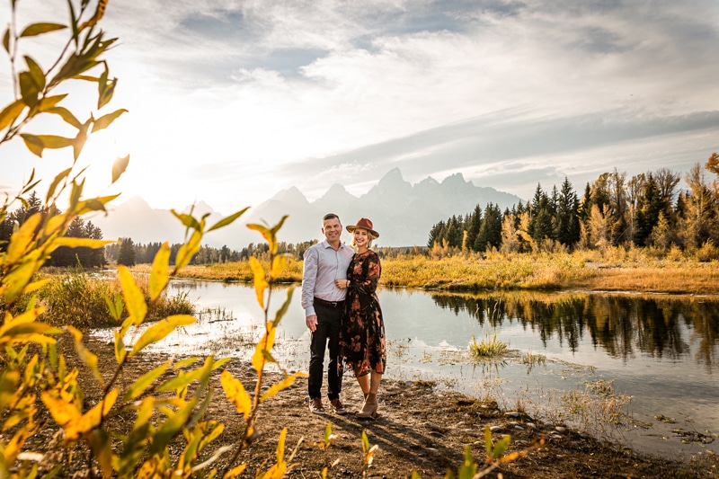 Couples photographer, a young couple hold each other close near mountain waters