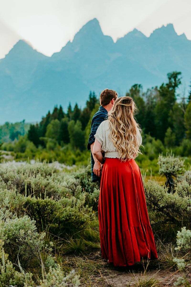 Family Photographer, a man and woman hold hands in mountain chaparral