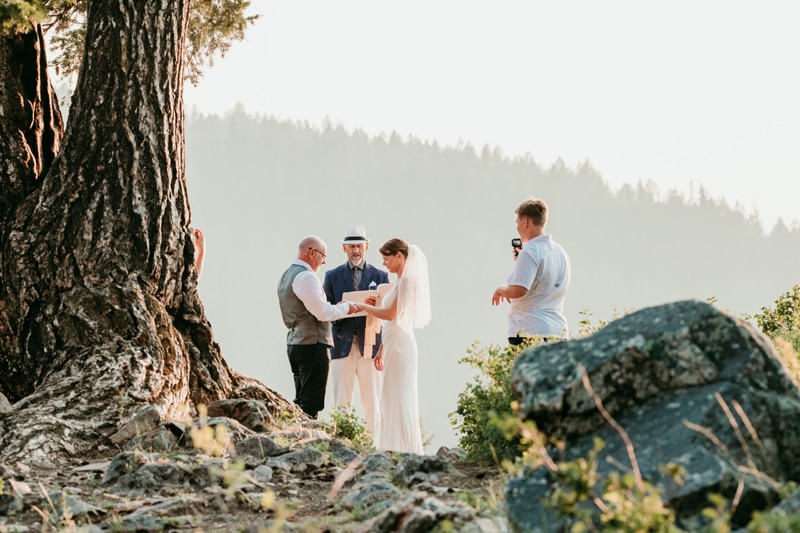 Wedding Photography, a small elopement ceremony with bride, groom, officiant and videographer happens in the mountains
