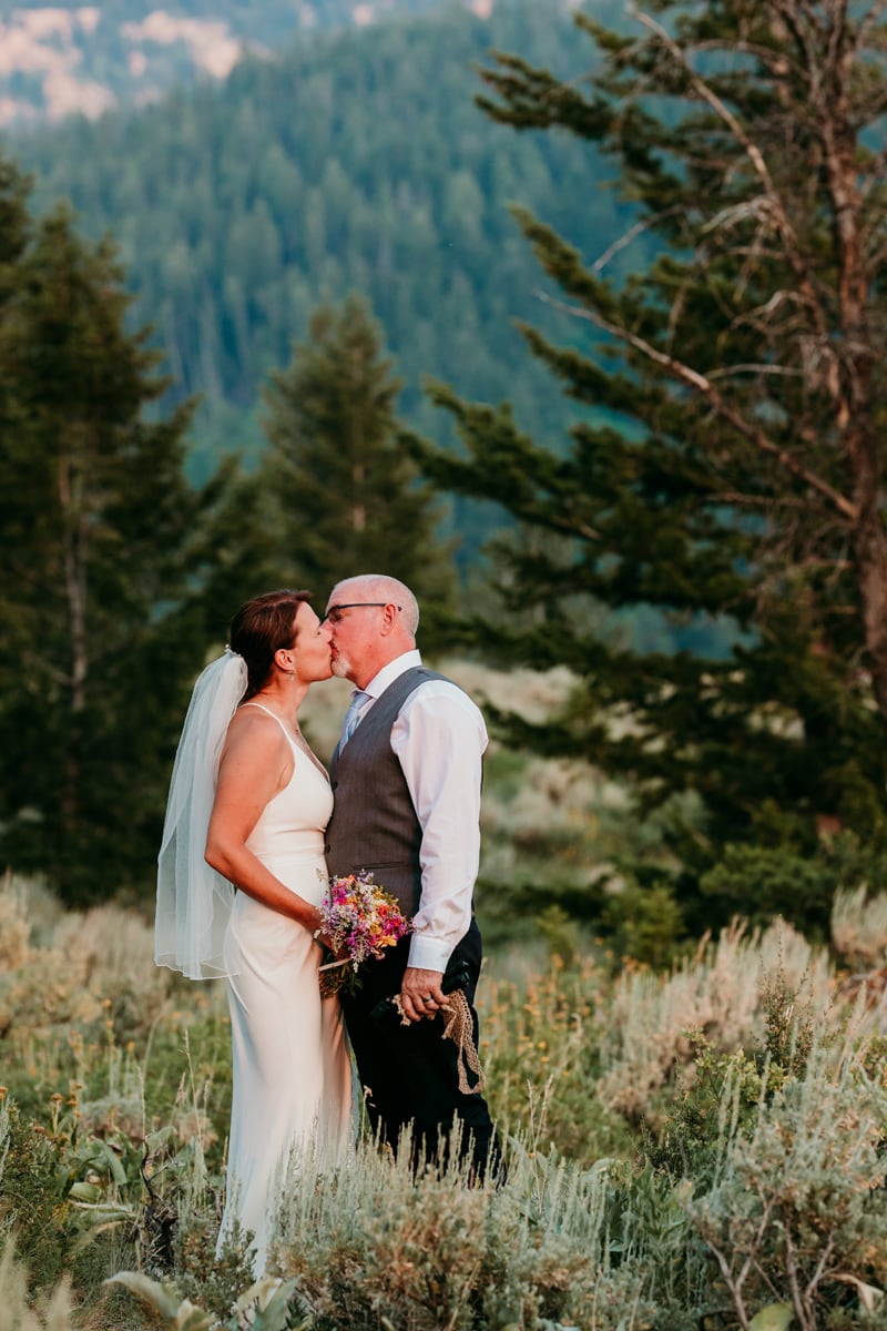Wedding Photography, a bride and groom kiss in mountain chaparral near the forest