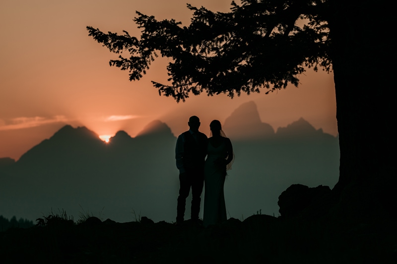 Wedding Photography, a silhouette of bride and groom at dusk before the mountains
