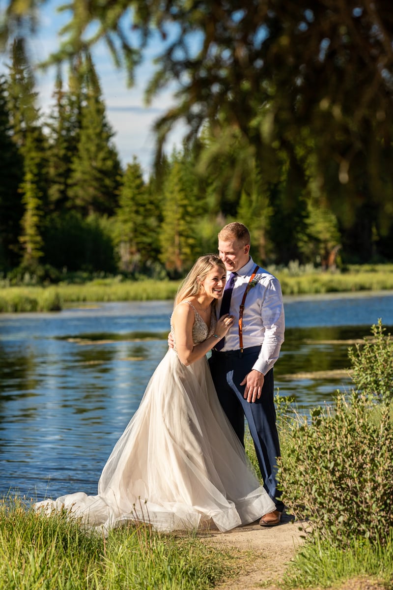 Wedding Photography, a bride and groom laugh together near a quiet river